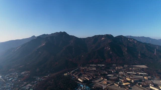 Distant View of a Town Nestled in Mountains