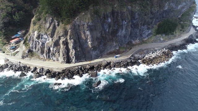 Coastal Road Along Rocky Cliffs and Waves