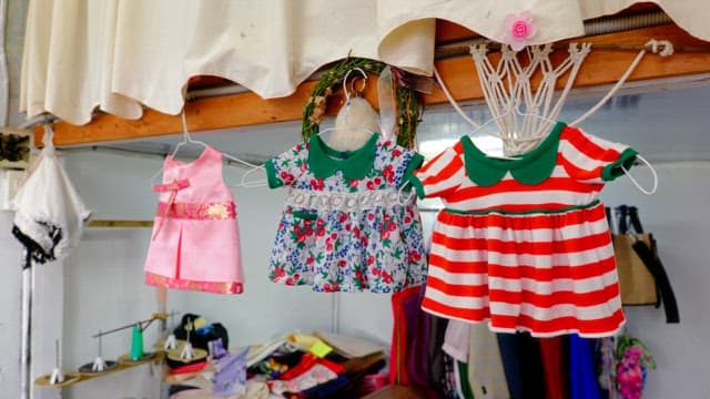Children's dresses hanging inside a workshop