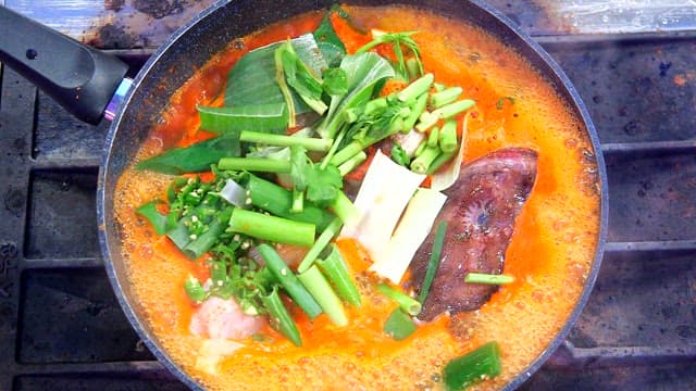 Spicy shaggy sea raven stew boiling in a pot