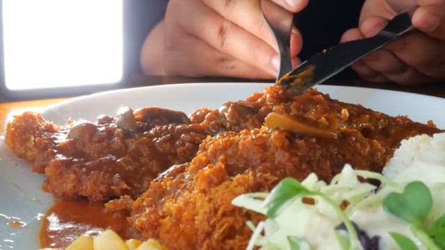 Close-up of a deliciously cheesy katsu meal