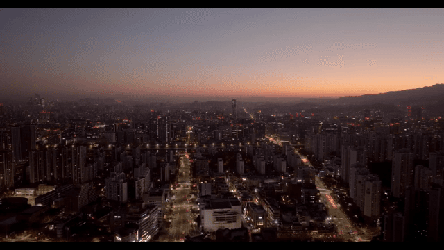 City skyline at dusk with glowing lights