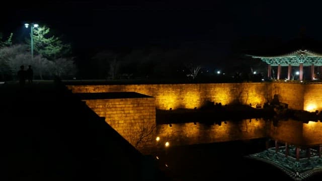 Night view of a traditional pavilion with illuminated walls