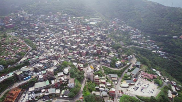 Sprawling hillside town with dense buildings