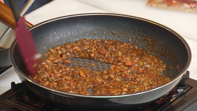 Stir-frying minced vegetables and meat with sauce on frying pan
