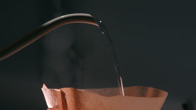 Pouring water into a coffee filter with a kettle