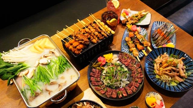 Table generously laid out with a variety of Japanese cuisine