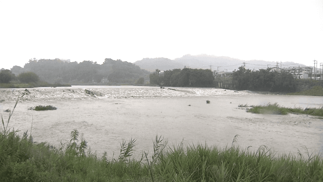 Swollen River Flowing under Rainfall
