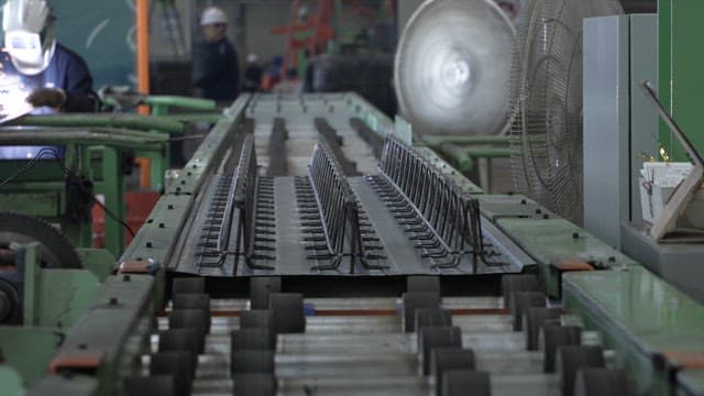 Workers operating machinery in a factory