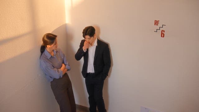 Two people having a conversation in a hallway