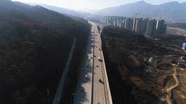 Traffic on a Highway by Mountains