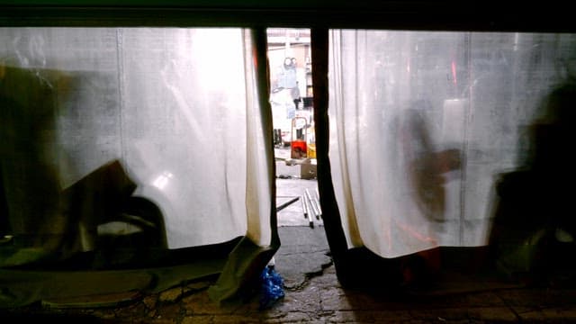 Industrial workshop visible through plastic curtains
