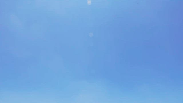 View of the village from a lush mountain under a clear sky