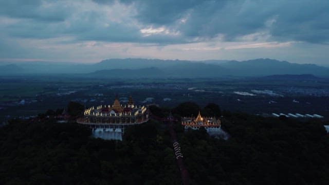 Magnificent temple on top of Mandalay Hill surrounded by nature at dusk