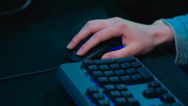 Hands using a computer mouse