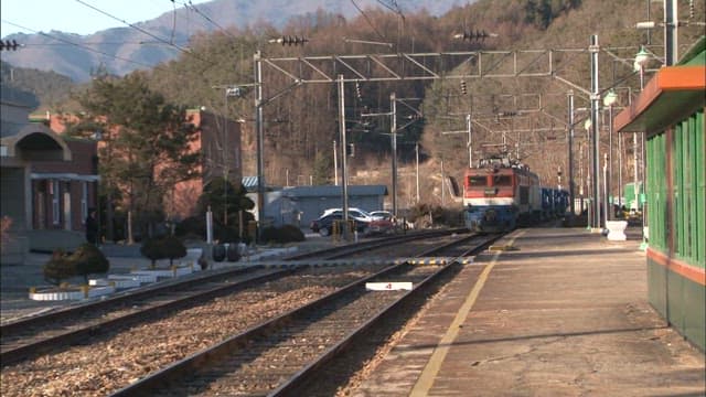 Train Approaching a Rural Station Platform