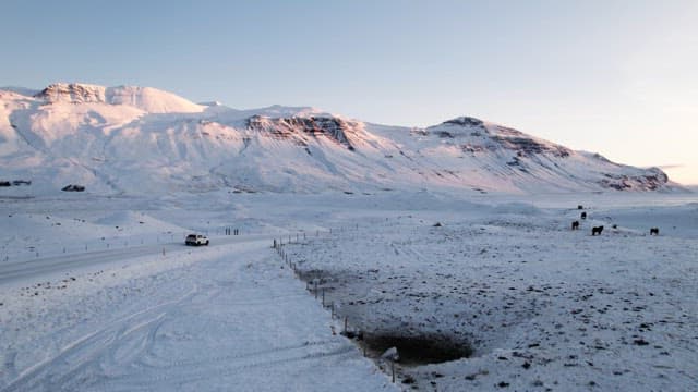 Snowy mountain landscape with a car