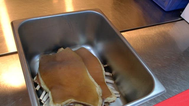 Boiled meat in a metal container in the kitchen