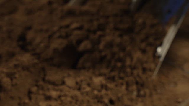 Scene of digging out dirt with a shovel