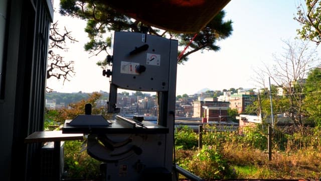 Industrial machine with cityscape in the background