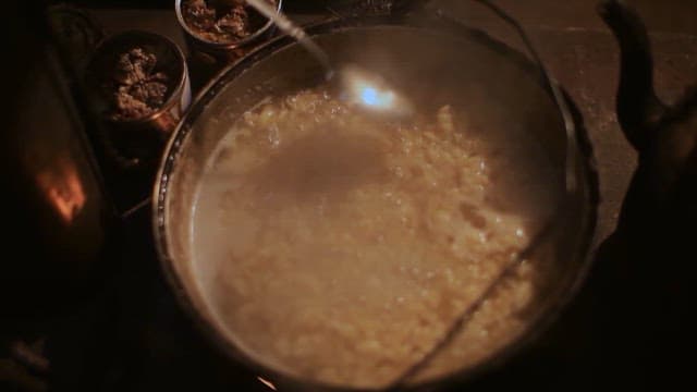 Cooking a Traditional Meal Over Fire