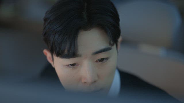 Man in a suit working at a desk