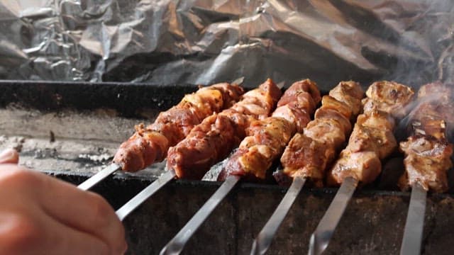 Skewering and Grilling Raw Marinated Meat