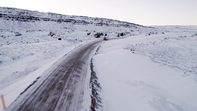 Car driving through a snowy landscape