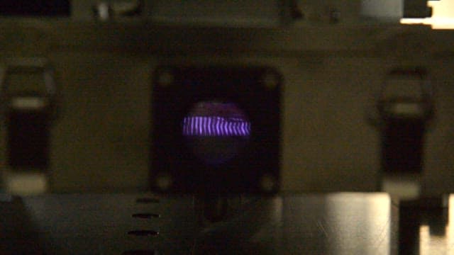 Device with a glowing purple plasma light