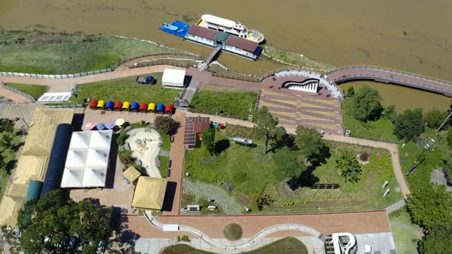 City park full of green and colorful structures on a sunny day