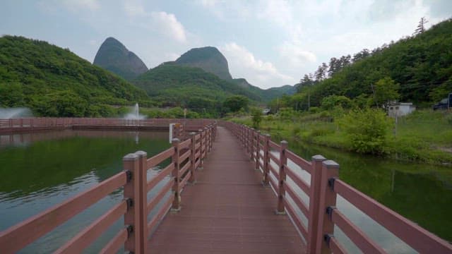 Serene Lake with Water Fountain and Mountains