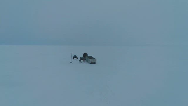 Ice Fishing in the Vast Snowy Wilderness