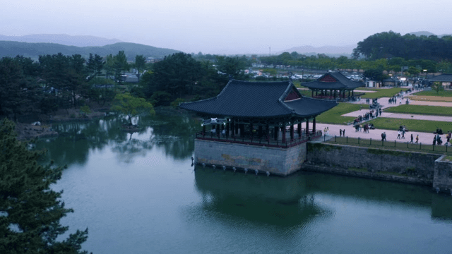 Drone Flying over Serene Lakeside and Pavilion
