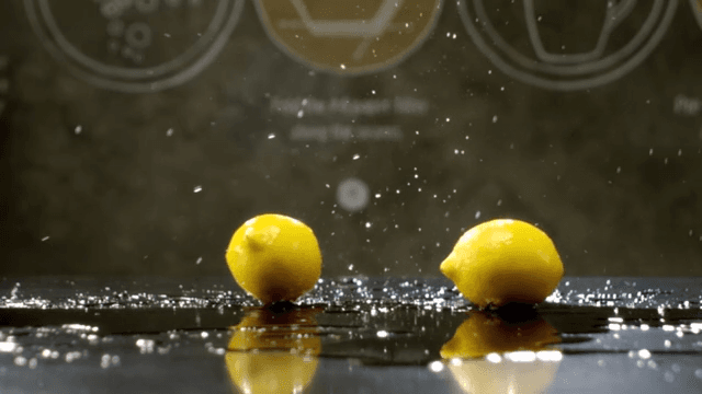Lemons rolling over a shiny surface
