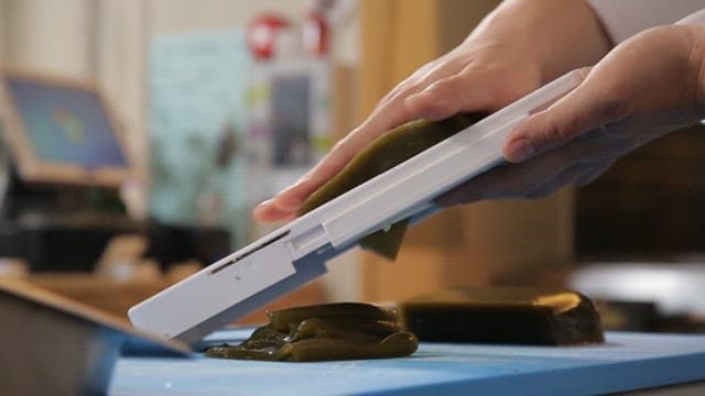 Cutting the jelly with a grater in the kitchen