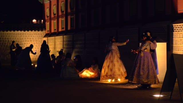 Tourists enjoying Gyeongbokgung Palace wearing Hanbok and taking pictures