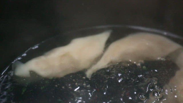 Dumplings boiling in hot water until ready