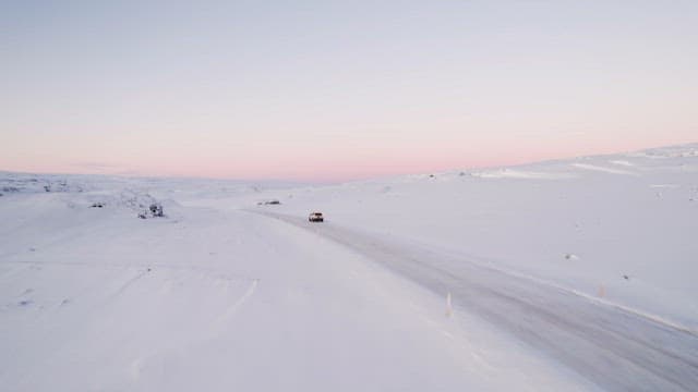Car driving through a snowy landscape