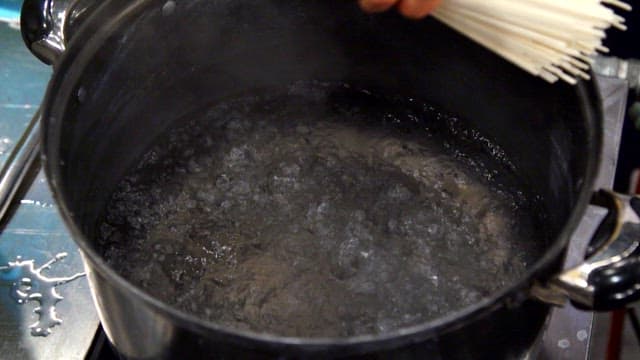 Noodles being added to boiling water