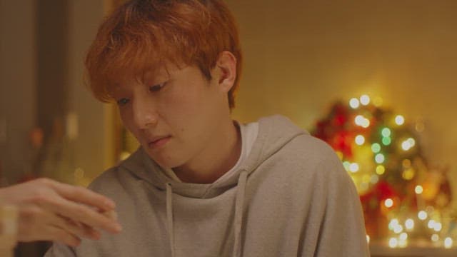 Man feeling depressed in a room decorated with Christmas lights