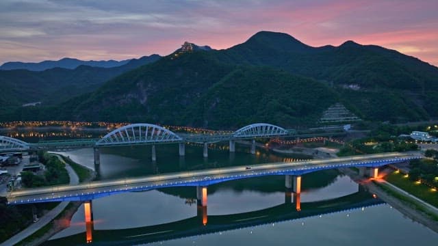 Serene river with bridges at dusk
