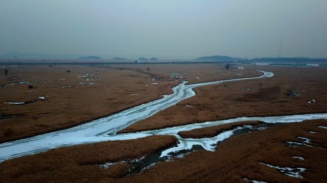 Vast marshland with a frozen river