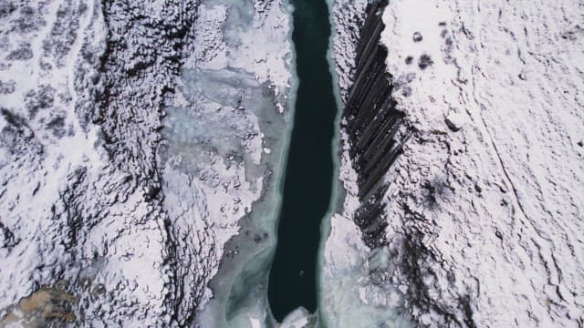 Snow-covered canyon with a frozen river