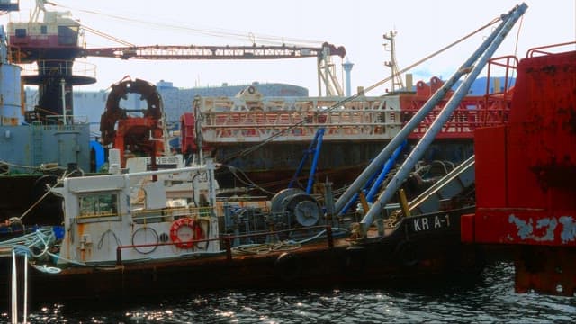 Industrial maritime equipment at a busy harbor