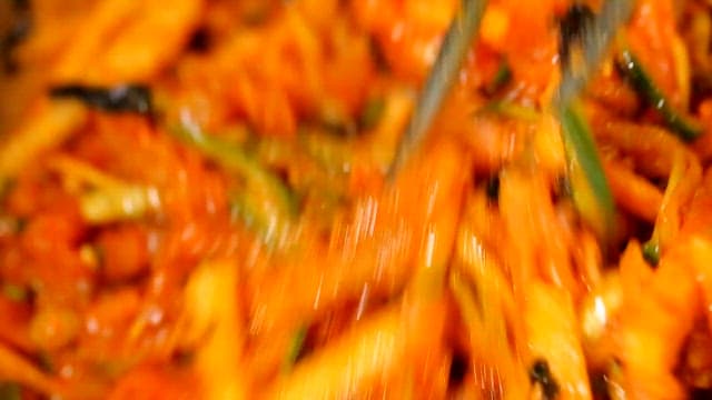 Stirring cold raw fish soup with chopsticks