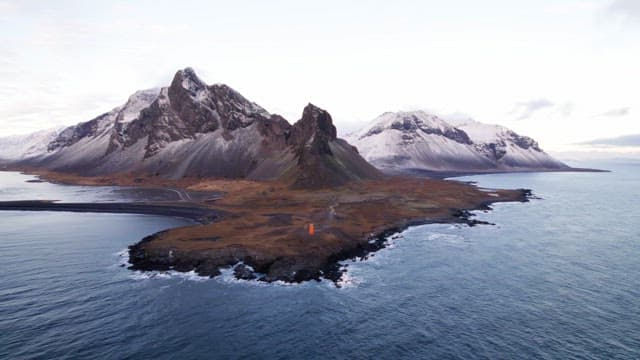 Snow-capped mountains by the ocean