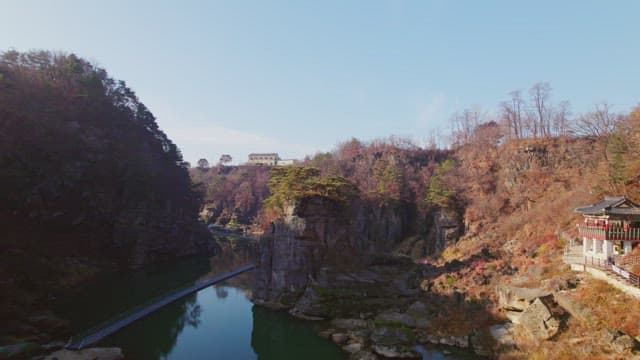 Serene river with rocky cliffs and trees
