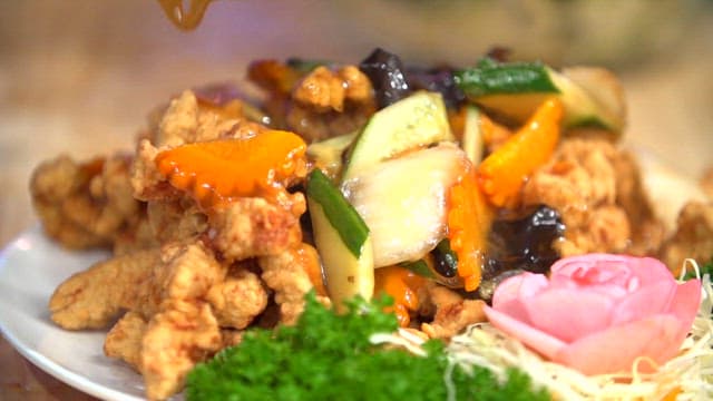 Sweet and sour sauce poured over fried meat