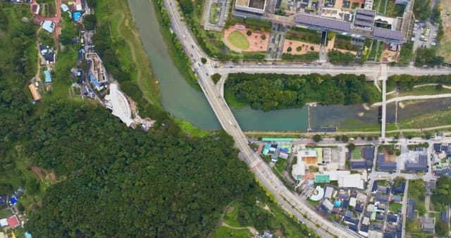 View of a city with a river and greenery