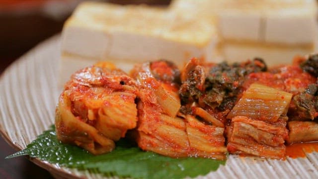 Grilled tofu and kimchi with large-eyed herring on a plate